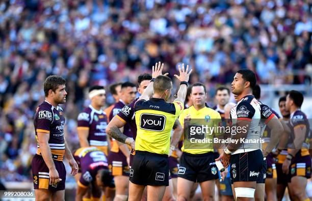 Referee Grant Atkins sin bins Tevita Satae of the Warriors and Andrew McCullough of the Broncos during the round 18 NRL match between the Brisbane...