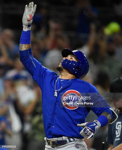 Javier Baez of the Chicago Cubs points skyward after hitting a three-run home run during the ninth inning of a baseball game against the San Diego...