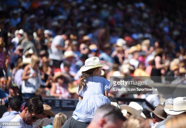Young cowgirl sits on her father's shoulders at the Calgary Stampede on July 14, 2018 at Stampede Park in Calgary, AB.