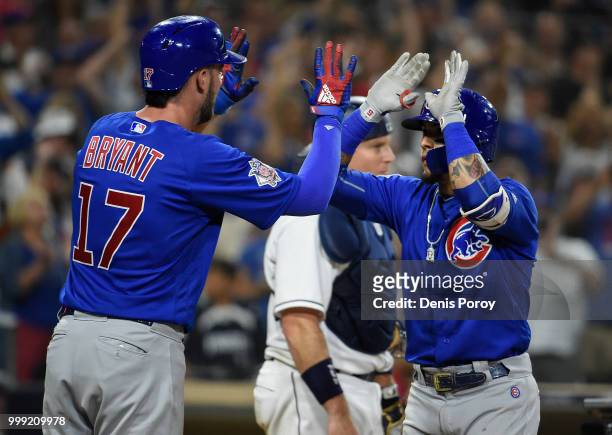 Javier Baez of the Chicago Cubs is congratulated by Kris Bryant after hitting a three-run home run during the ninth inning of a baseball game against...