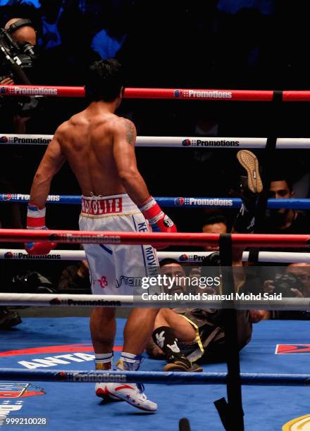 Argentina's Lucas Matthysse fall during fight with Philippine's Manny Pacquiao for their World welterweight boxing championship title bout in Kuala...