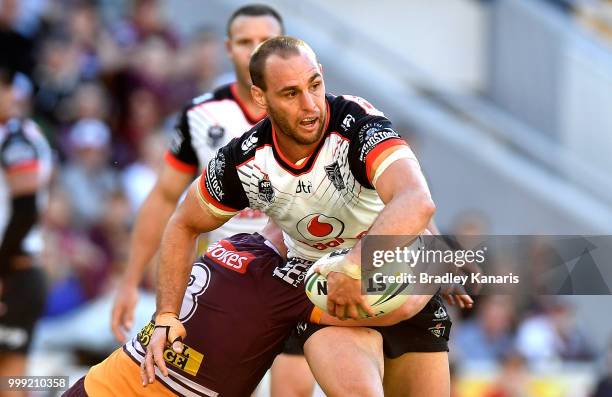 Simon Mannering of the Warriors is tackled during the round 18 NRL match between the Brisbane Broncos and the New Zealand Warriors at Suncorp Stadium...