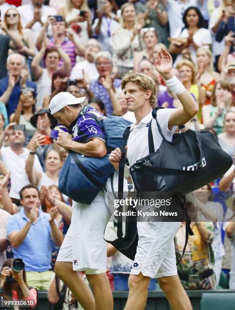 Kevin Anderson of South Africa acknowledges the crowd as he leaves the court after winning 7-6, 6-7, 6-7, 6-4, 26-24 against John Isner of the United...