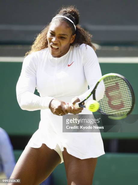 Serena Williams of the United States hits a backhand against Angelique Kerber of Germany during the Wimbledon final match in London on July 14, 2018....