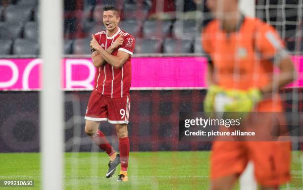 Muenchen's Robert Lewandowski celebrates his 3-0 goal during the German Bundesliga soccer match between Bayern Muenchen and Bayer Leverkusen in the...