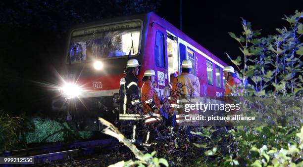 Firefighters stand next to regional train at the railway section near Uhlingen, Germany, 18 August 2017. Earlier, the train collided with a fallen...