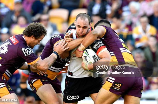 Simon Mannering of the Warriors is tackled during the round 18 NRL match between the Brisbane Broncos and the New Zealand Warriors at Suncorp Stadium...