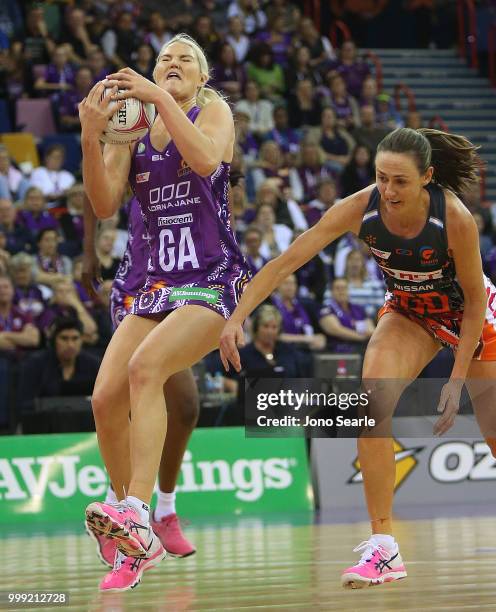 Gretel Tippett of the Firebirds secures the ball past Rebecca Bulley of the Giants during the round 11 Super Netball match between the Firebirds and...