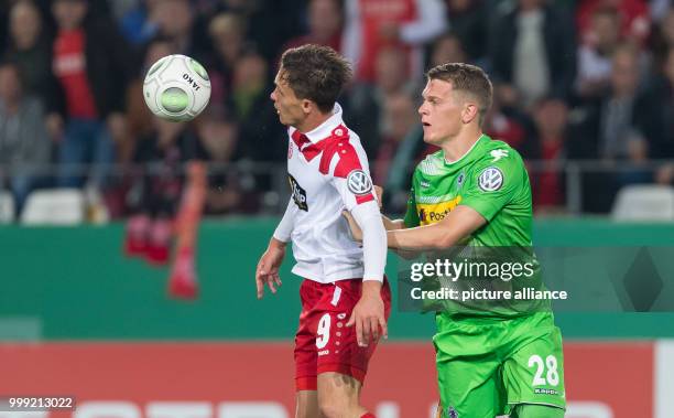 Gladbach's Matthias Ginter and Essen's Marcel Platzek vie for the ball during the German Soccer Association Cup first round soccer match between Rot...