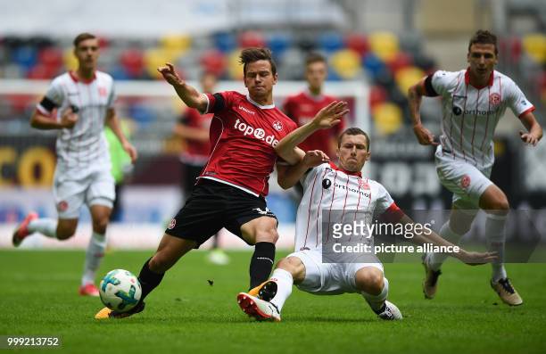 Kaiserslautern's Mads Albaek and Duesseldorf's Oliver Fink vie for the ball during the German Second Bundesliga soccer match between Fortuna...