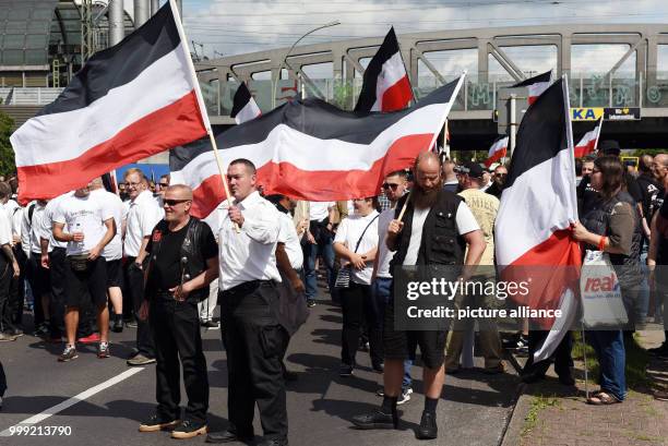 Right-wing extremists walk across the street to commemorate the 30th anniversary of the death of Hitler's deputy Rudolf Hess at the Spandau train...