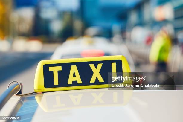 taxi cars on the street - taxi sign stock pictures, royalty-free photos & images