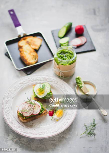 roasted bread with green pesto and egg - pesto stock pictures, royalty-free photos & images