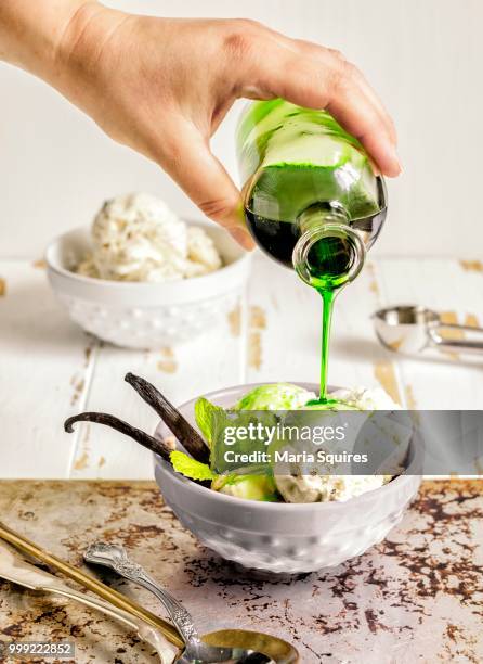 vanilla ice cream with mint syrup - mint ice cream stock pictures, royalty-free photos & images