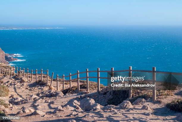 view od cabo da roca in sintra - roca cape - cliffs and fence at sunset - roca 個照片及圖片檔