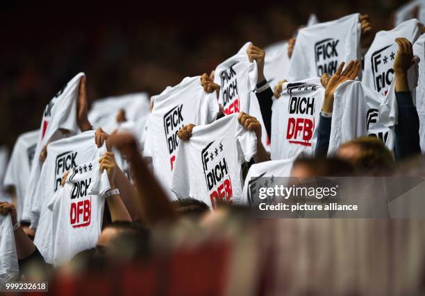 The Duesseldorf fans hold up T-Shirts saying 'F*** dich DFB' during the German Second Bundesliga soccer match between Fortuna Duesseldorf and 1. FC...
