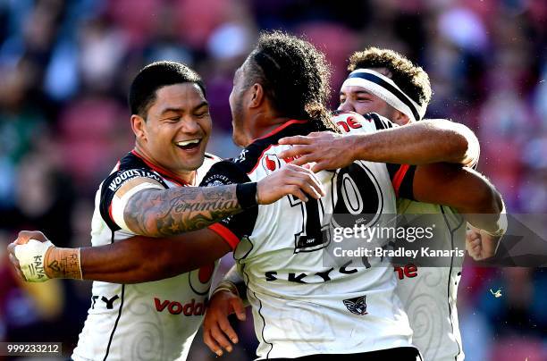 Agnatius Paasi of the Warriors is congratulated by team mates after scoring a try during the round 18 NRL match between the Brisbane Broncos and the...