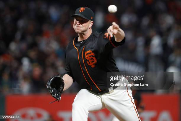 Tony Watson of the San Francisco Giants delivers a pitch during the seventh inning against the Oakland Athletics at AT&T Park on July 14, 2018 in San...
