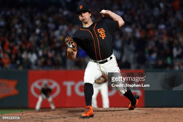 Derek Holland of the San Francisco Giants delivers a pitch during the fifth inning against the Oakland Athletics at AT&T Park on July 14, 2018 in San...