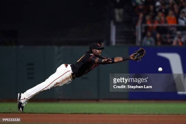 Alen Hanson of the San Francisco Giants couldn't catch a ball hit by Josh Phegley of the Oakland Athletics during the seventh inning of their MLB...