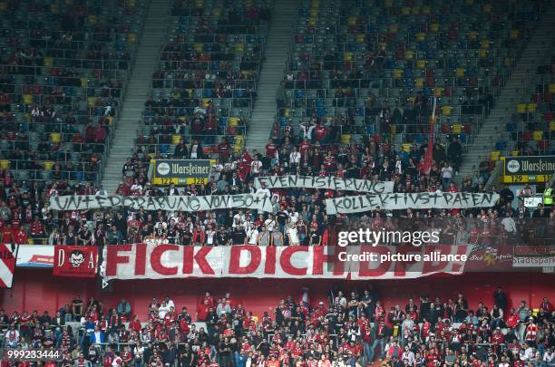 Kaiserslautern's fans hold up banners saying 'Untergrabung von 50+1' , 'Eventisierung' , 'Kollektivstrafen' and 'Fick dich DFB!' during the German...