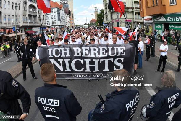 Right-wing extremists walk across the street to commemorate the 30th anniversary of the death of Hitler's deputy Rudolf Hess at the Spandau train...