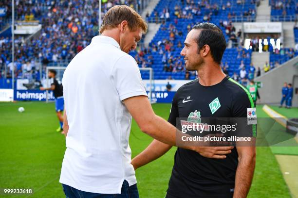 Hoffenheim's coach Julian Nagelsmann and Bremen's coach Alexander Nouri greet each other before the beginning of the German Bundesliga soccer match...