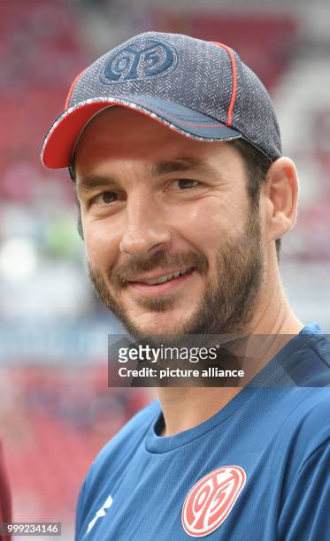 Mainz's coach Sandro Schwarz smiles at the German Bundesliga soccer match between FSV Mainz 05 and Hannover 96 in the Opel Arena in Mainz, Germany,...