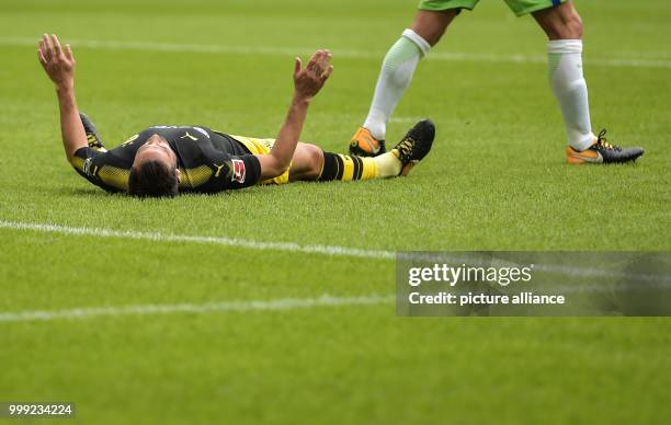 Dortmund's Gonzalo Castro lies on the ground after his missed chance at scoring a goal during the German Bundesliga soccer match between VfL...