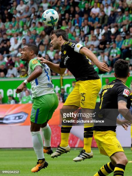 Wolfsburg's Daniel Didavi and Dortmund's Sokratis Papastathopoulos vie for the ball during the German Bundesliga soccer match between VfL Wolfsburg...