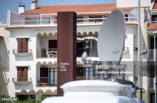 The satellite dish of a broadcasting vehicle can be seen in front of a column saying 'Porta del mar' on the promenade of Cambrils, Spain, 19 August...
