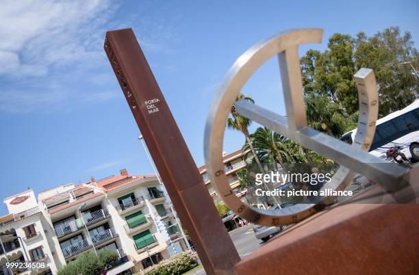 Navigational instrument in front of a column saying 'Porta del mar' can be seen on the promenade of Cambrils, Spain, 19 August 2017. In the beach...