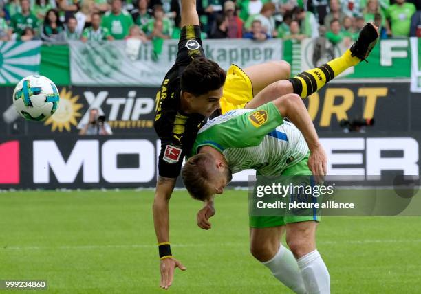 Wolfsburg's Jakub Blaszczykowski and Dortmund's Marc Bartra vie for the ball during the German Bundesliga soccer match between VfL Wolfsburg and...