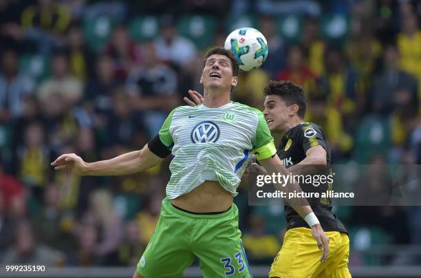 Wolfsburg's Mario Gomez and Dortmund's Marc Bartra vie for the ball during the German Bundesliga soccer match between VfL Wolfsburg and Borussia...