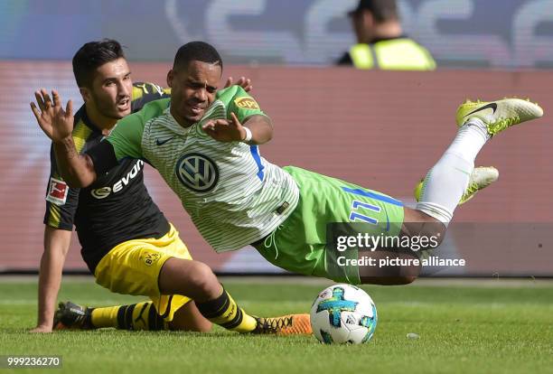 Wolfsburg's Daniel Didavi and Dortmund's Nuri Sahin vie for the ball during the German Bundesliga soccer match between VfL Wolfsburg and Borussia...