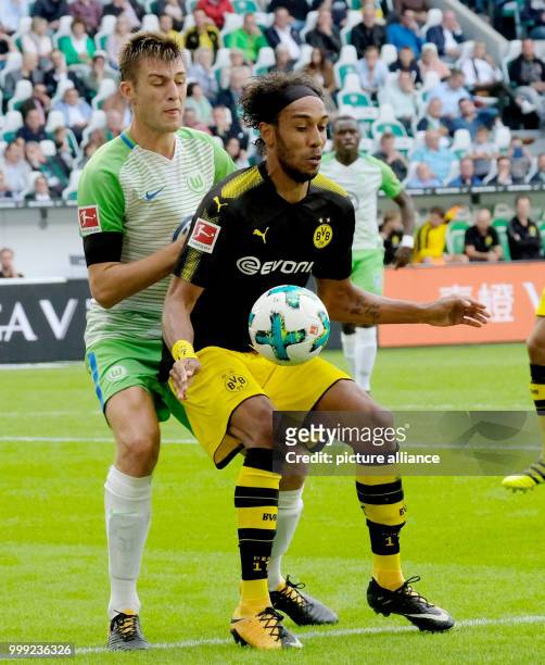 Wolfburg's Robin Knoche and Dortmund's Pierre-Emerick Aubameyang vie for the ball during the German Bundesliga soccer match between VfL Wolfsburg and...