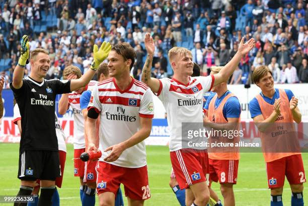 Hamburg players celebrate their victory after the German Bundesliga soccer match between Hamburger SV and FC Augsburg in the Volksparkstadion in...