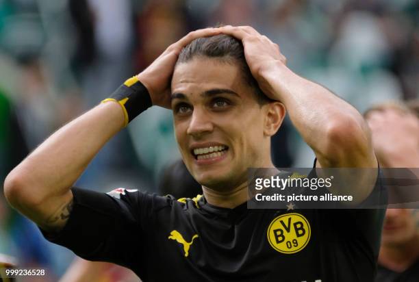 Dortmund's Marc Bartra stands on the pitch after the ending of the German Bundesliga soccer match between VfL Wolfsburg and Borussia Dortmund in the...