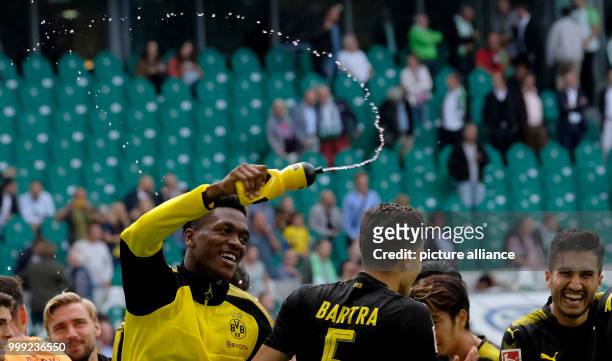 Dortmund's Dan-Axel Zagadou , Marc Bartra and Nuri Sahin stand on the pitch after the ending of the German Bundesliga soccer match between VfL...