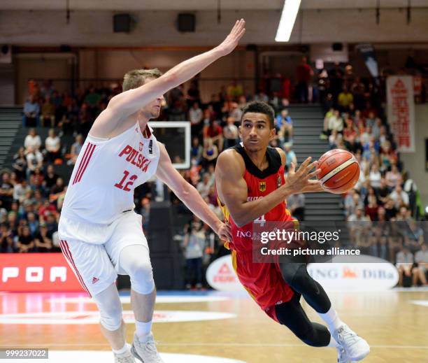 Germany's Maodo Lo and Poland's Adam Waczynski vie for the ball during the basketball Supercup match between Germany and Poland in the edel-optics.de...