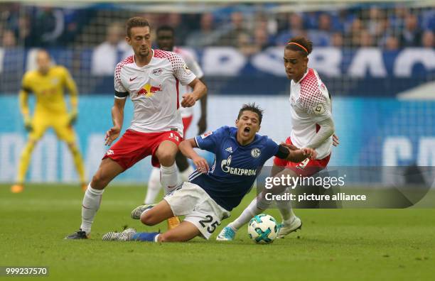 Schalke's Amine Harit vies with Leipzig's Yussuf Poulsen for the ball during the German Bundesliga soccer match between FC Schalke 04 and RB Leipzig...