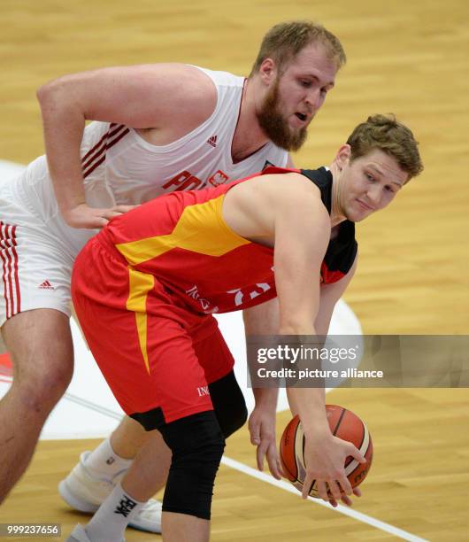 Germany's Patrick Heckmann and Poland's Przemyslaw vie for the ball during the basketball Supercup game between Germany and Poland at the...