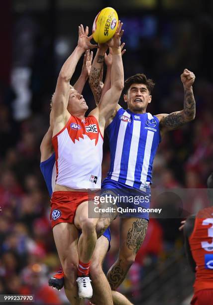 Isaac Heeney of the Swans marks infront of Marley Williams of the Kangaroos during the round 17 AFL match between the North Melbourne Kangaroos and...