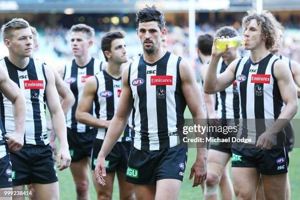 Scott Pendlebury of the Magpies looks dejected as he leads the team off after defeat during the round 17 AFL match between the Collingwood Magpies...