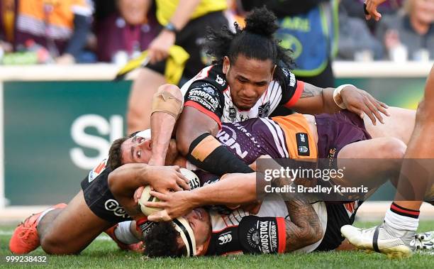 Andrew McCullough of the Broncos is held up over the line by the Warriors defence during the round 18 NRL match between the Brisbane Broncos and the...