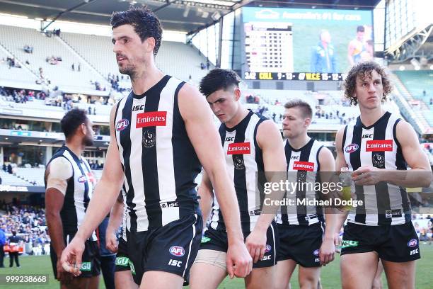 Scott Pendlebury of the Magpies looks dejected as he leads the team off after defeat during the round 17 AFL match between the Collingwood Magpies...