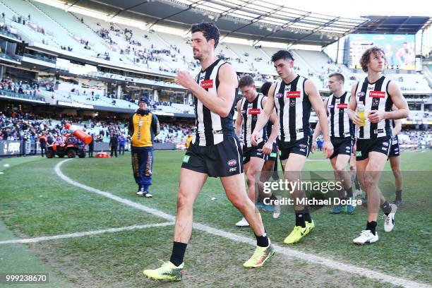 Scott Pendlebury of the Magpies looks dejected as he leads the team off after defeat during the round 17 AFL match between the Collingwood Magpies...