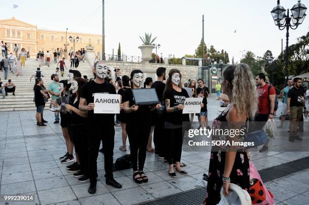 Activists with face masks are seen holding posters during the demonstration. Anonymous for the voiceless protest by the vegan activists on Syntagma...