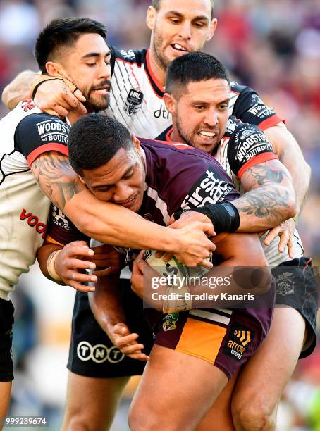 Patrick Mago of the Broncos is tackled during the round 18 NRL match between the Brisbane Broncos and the New Zealand Warriors at Suncorp Stadium on...