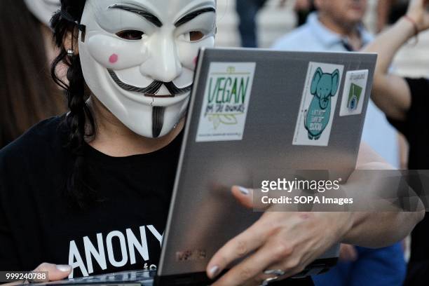 An activist with an anonymous face mask during a demonstration by vegan activists for the 'voiceless' on Syntagma Square.